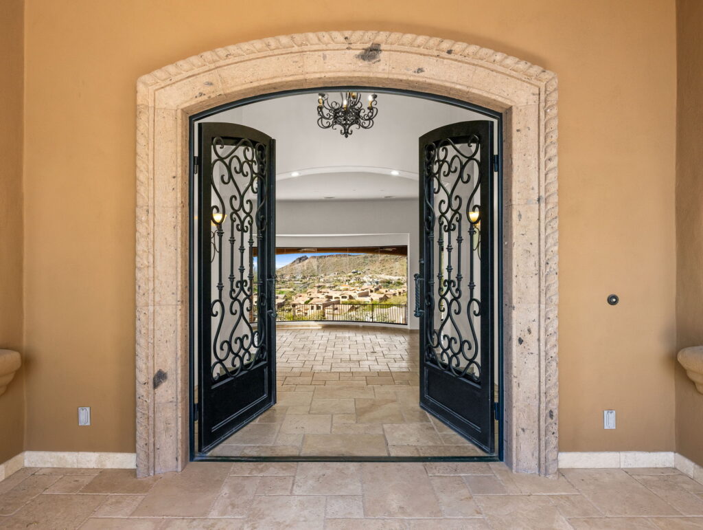 Sonoran Skyline at FireRock Country Club, Fountain Hills — sweeping living room with stone fireplace and valley views