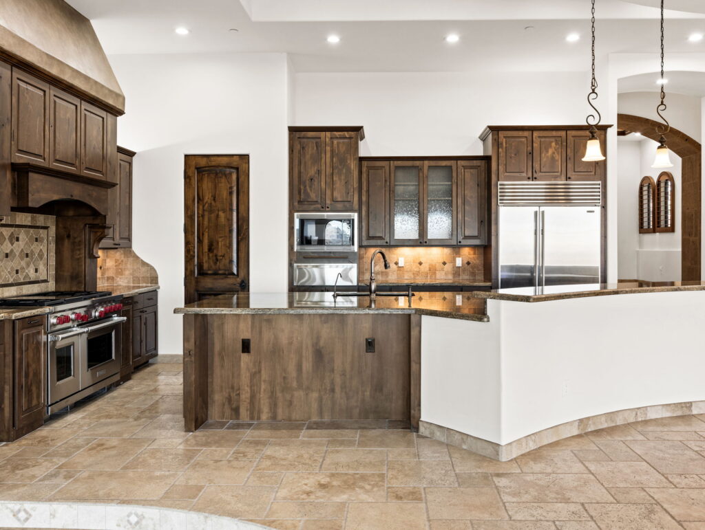 Sonoran Skyline kitchen with custom cabinetry, granite surfaces, Wolf appliances, and social island